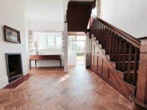 Bright Dorset coast holiday home with classic wood floors and seaside views.