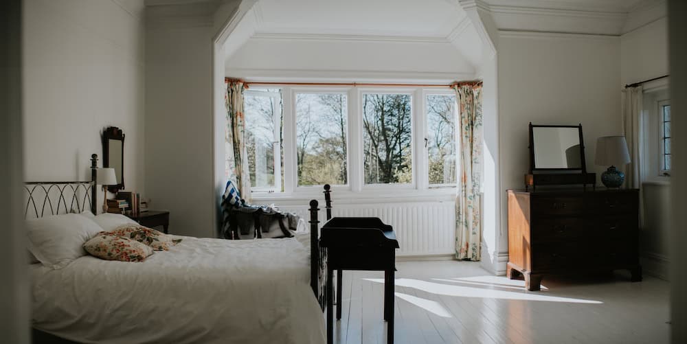 Bright bedroom overlooking the Dorset coast at Rushay, perfect for relaxing getaways.