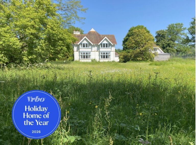 Rushay across the garden with the Holiday Home of the Year badge superimposed