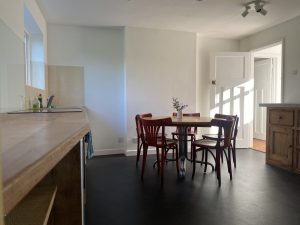 cottage kitchen with black lino floor